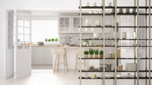 Kitchen living room shelving system foreground close-up, interior design concept, white modern room open plan in the background